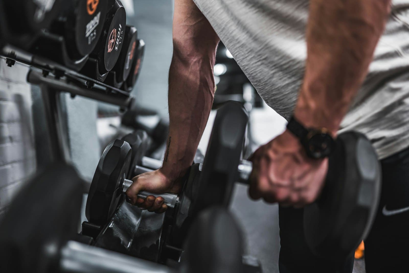 Man training with dumbbells — tasteful strength work